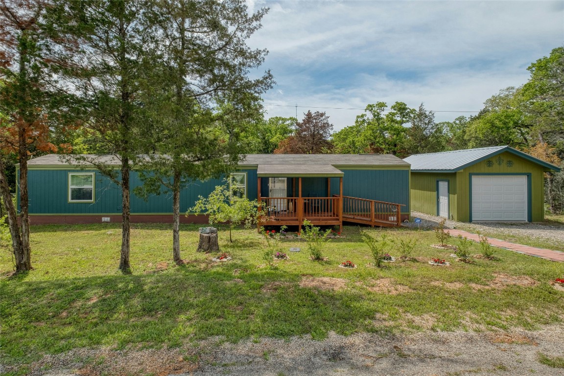 157 Commanche Drive Smithville, TX 78957 - Photo 1 of 1 a backyard of a house with barbeque oven table and chairs