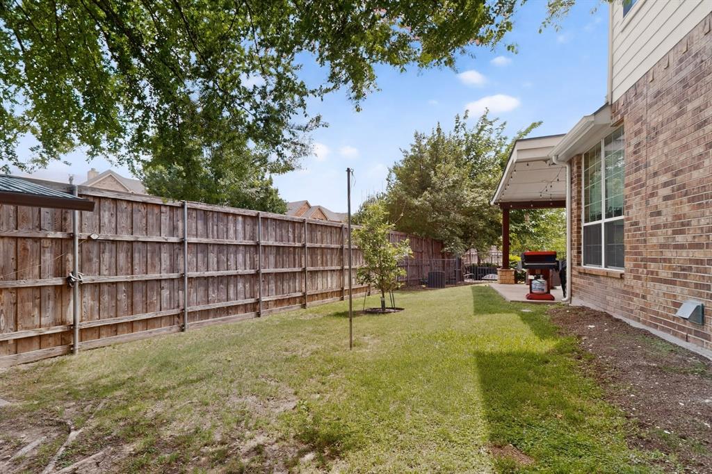 4004 White Porch Road Plano, TX 75024 - Photo 39 of 40 a view of a backyard with wooden fence and large trees