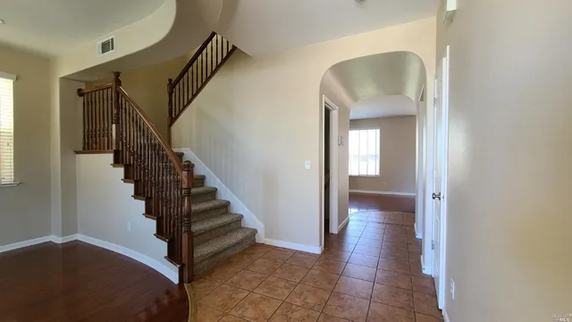a view of a hallway with wooden floor and entryway