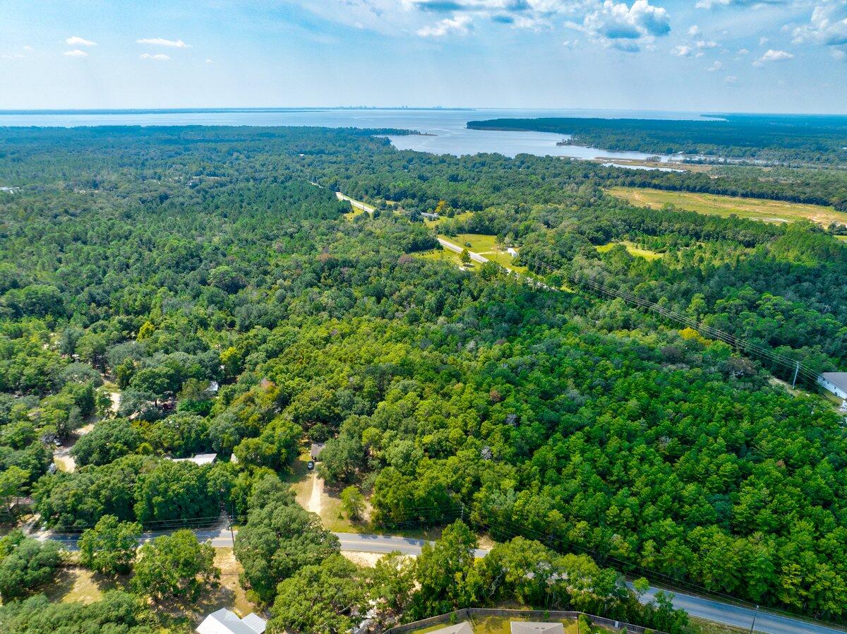 0 Earl Godwin Road Freeport, FL 32439 - Photo 5 of 9 an aerial view of a houses with a yard and lake view