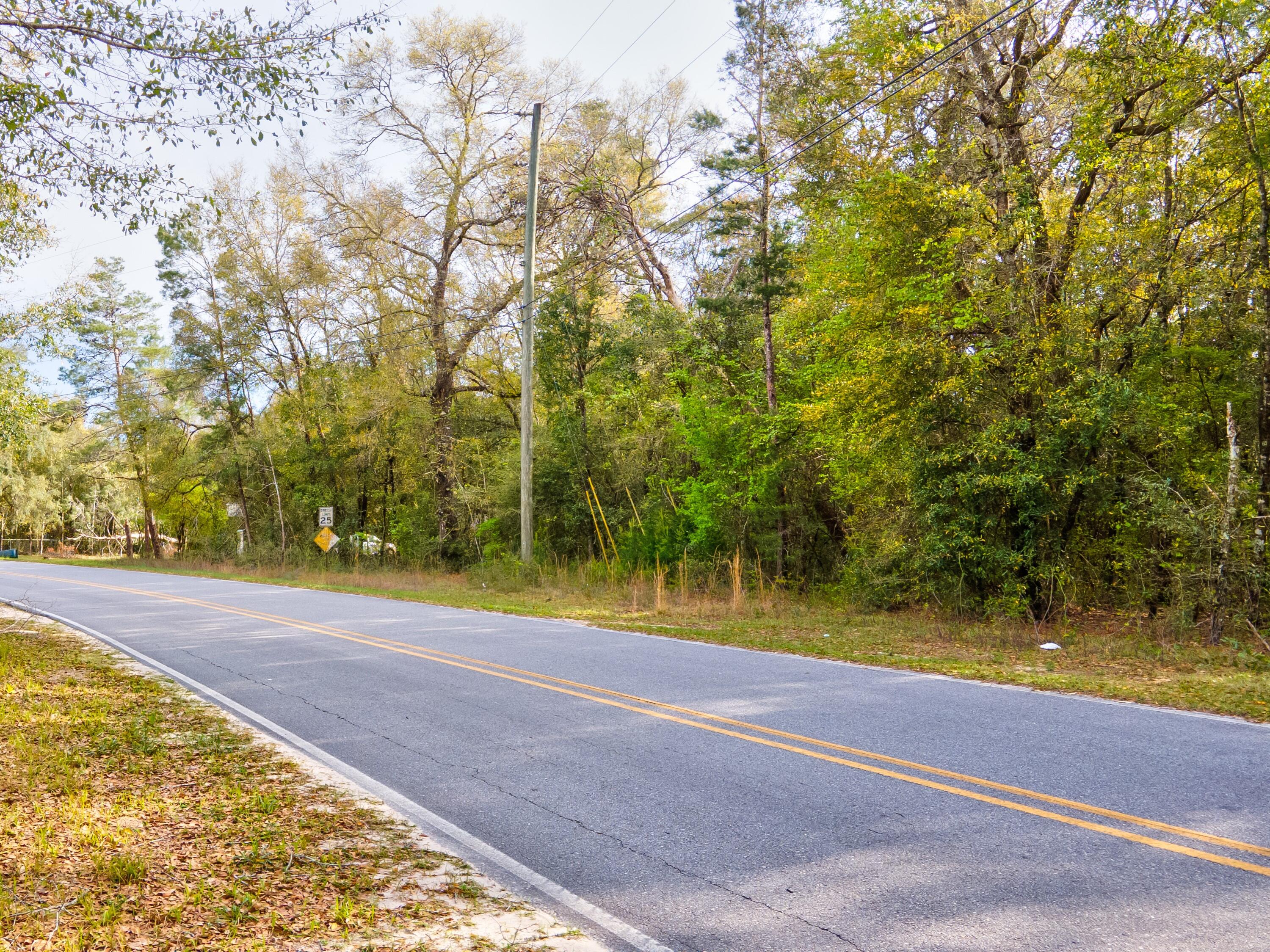 0 Earl Godwin Road Freeport, FL 32439 - Photo 6 of 9 a view of a swimming pool with an outdoor space and seating area