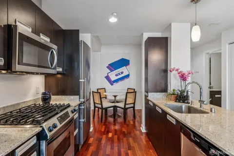 a kitchen with a stove a sink and a microwave