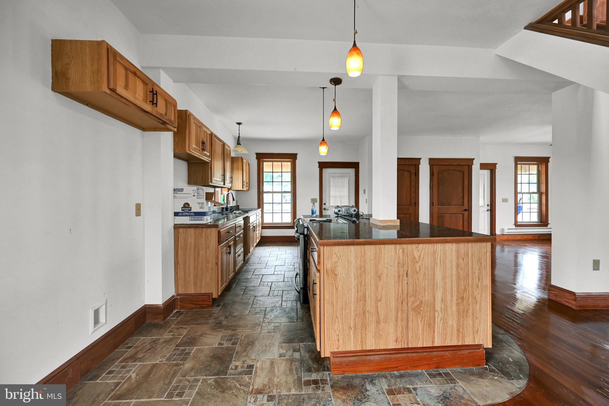 6800 Cannery Road Spring Grove, PA 17362 - Photo 5 of 23 a view of a living room with kitchen island granite countertop wooden floor and a view of kitchen