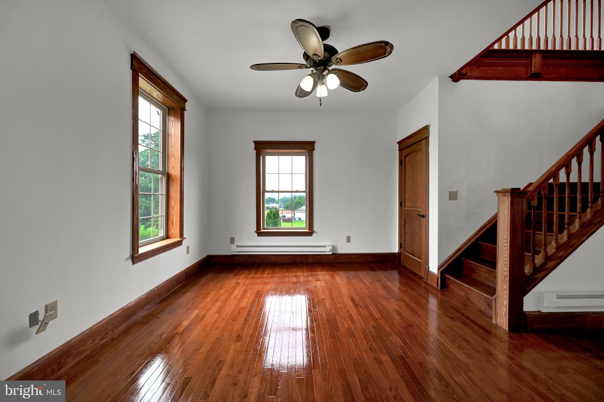 6800 Cannery Road Spring Grove, PA 17362 - Photo 8 of 23 a view of an empty room with wooden floor and a window