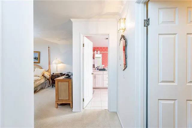 a bedroom with a bed and dresser with mirror