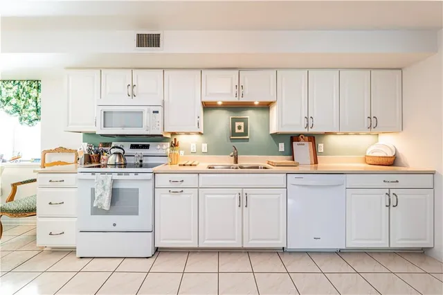 a kitchen with a sink and refrigerator