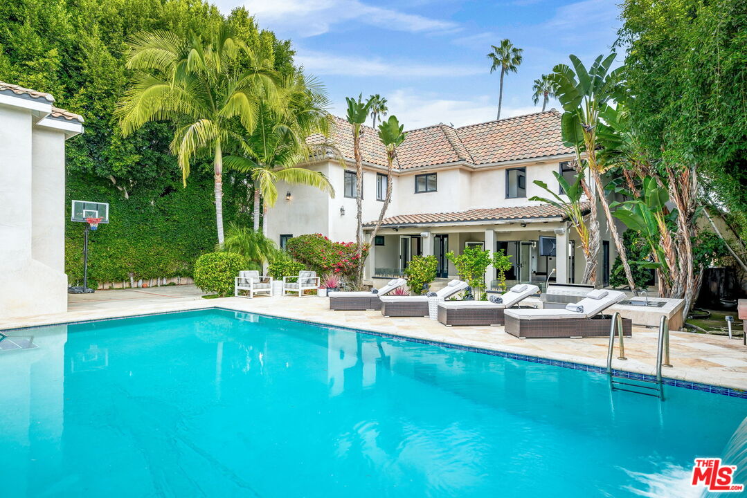 607 North Hillcrest Road Beverly Hills, CA 90210 - Photo 11 of 16 a view of a house with pool table and chairs