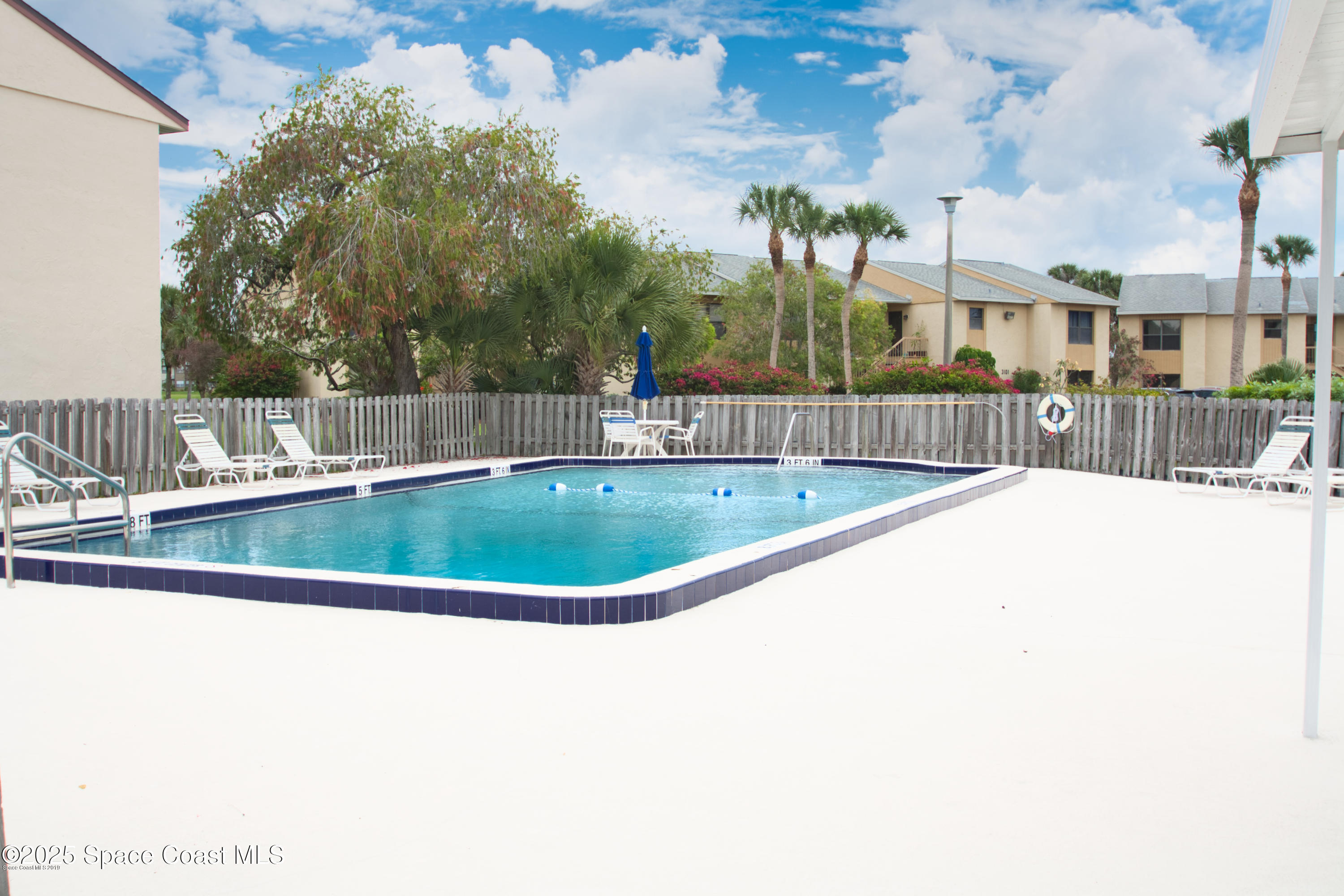 2550 Eagle Drive, Unit 3C Melbourne, FL 32935 - Photo 13 of 14 a view of a swimming pool with a patio