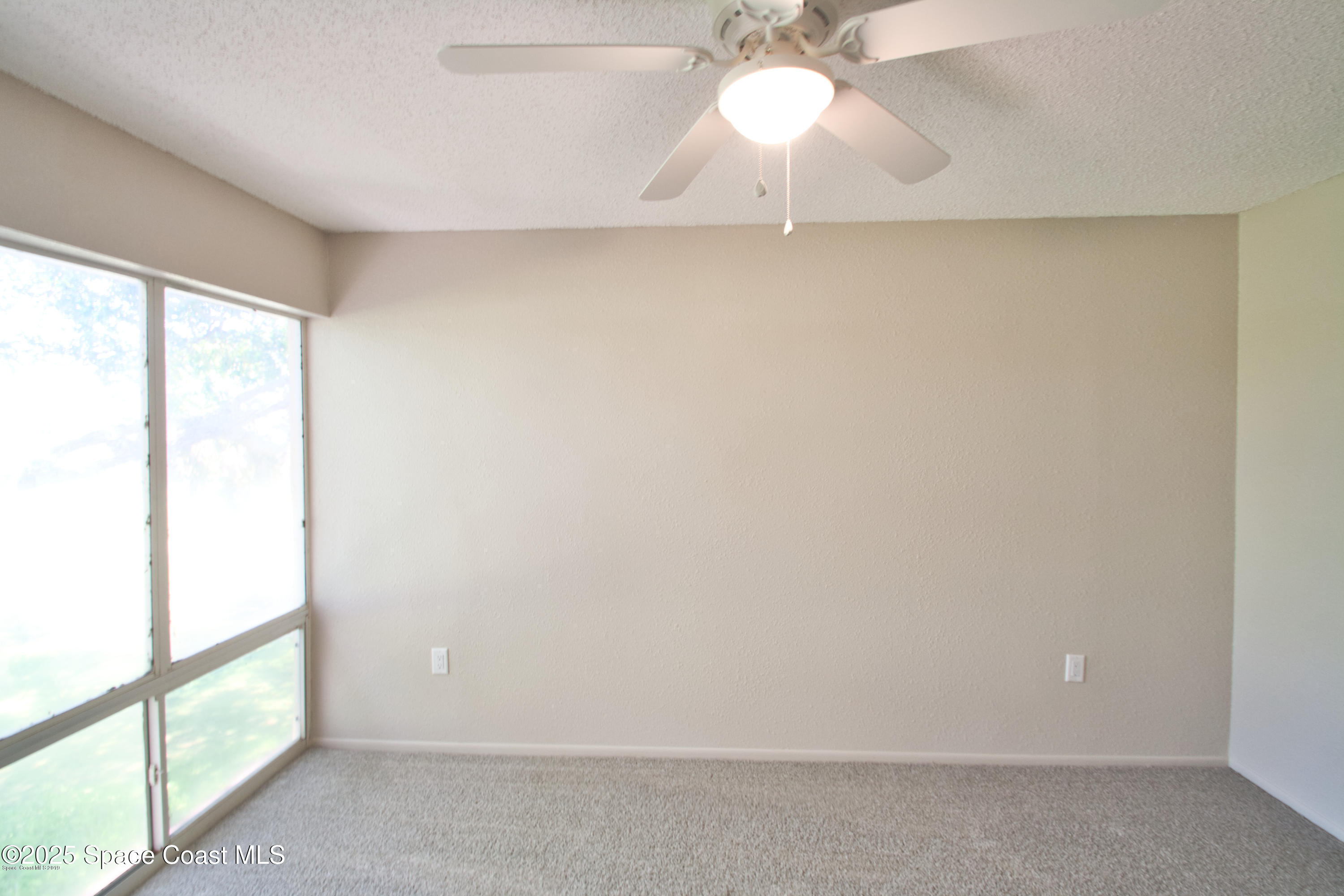 2550 Eagle Drive, Unit 3C Melbourne, FL 32935 - Photo 6 of 14 a view of an empty room with a window
