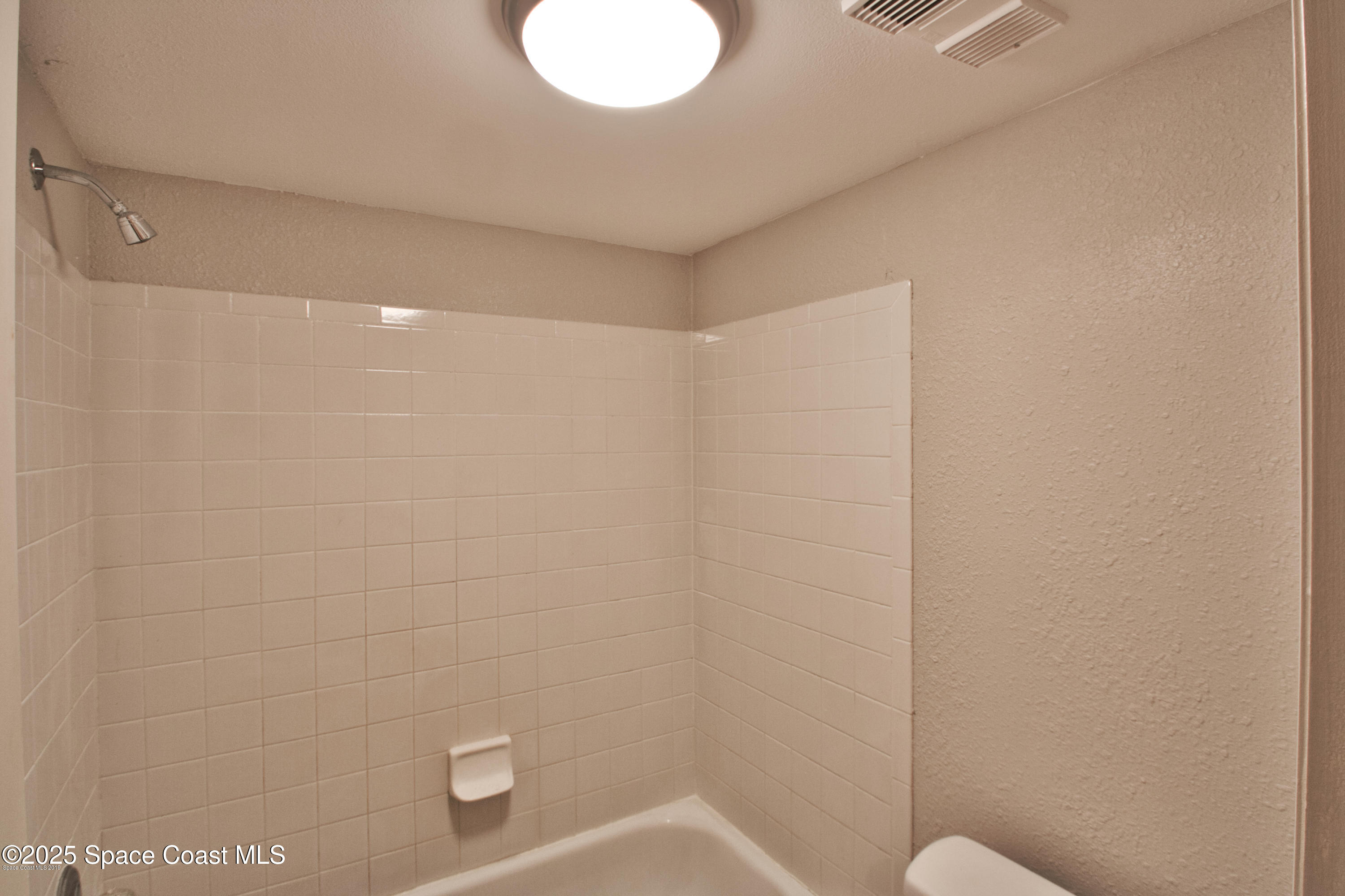 2550 Eagle Drive, Unit 3C Melbourne, FL 32935 - Photo 9 of 14 a bathroom with a shower and toilet