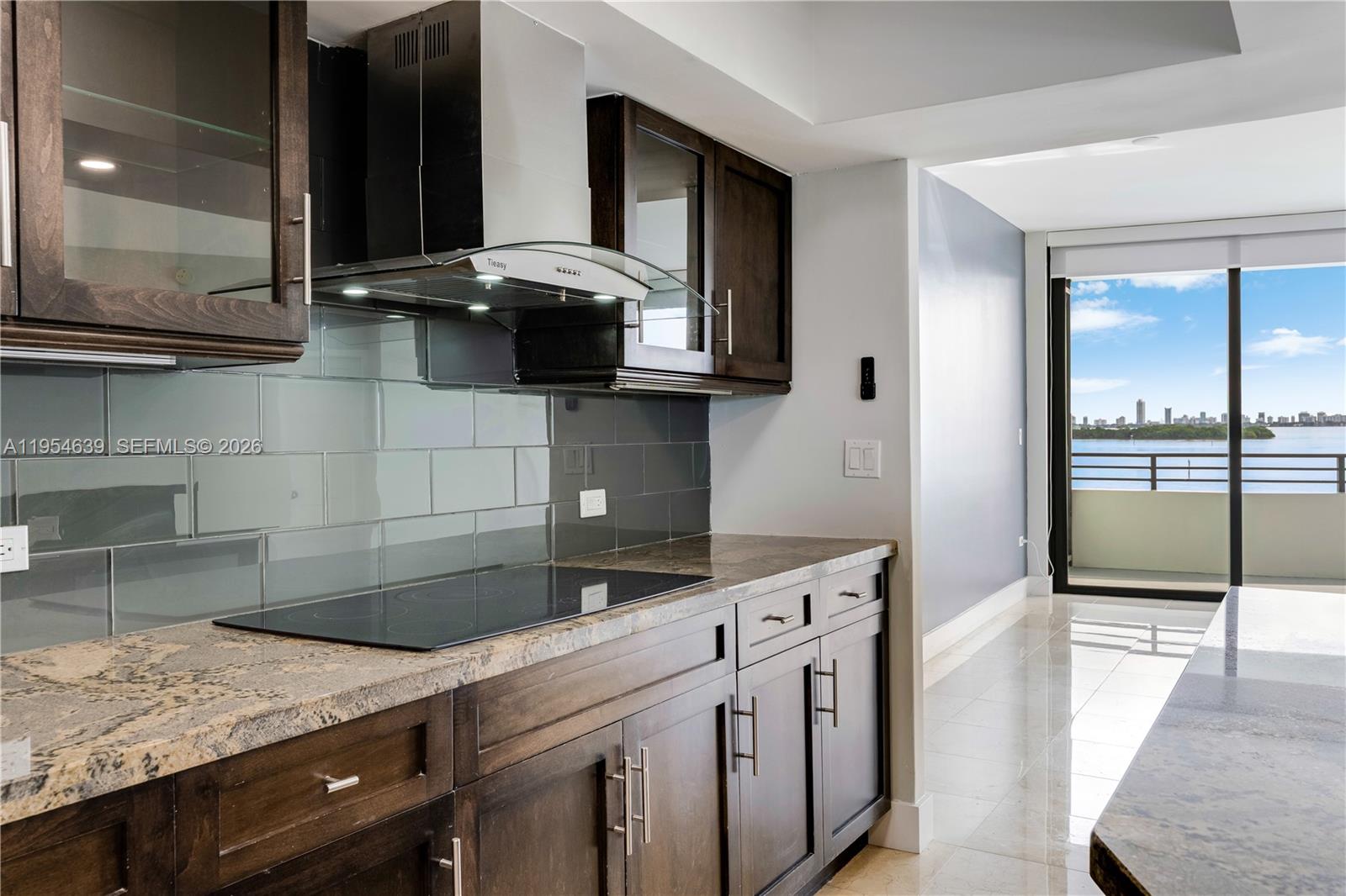 720 Northeast 69th Street, Unit 4S Miami, FL 33138 - Photo 16 of 46 a kitchen with stainless steel appliances granite countertop a sink and a stove