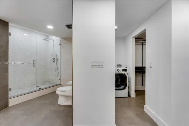 a bathroom with a toilet and a shower