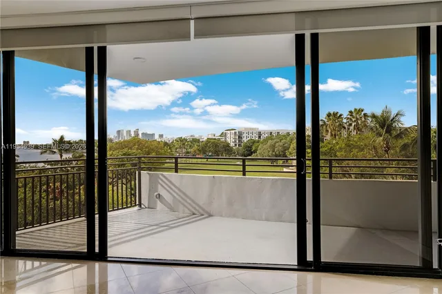a view of a glass door with a floor to ceiling window next to a yard