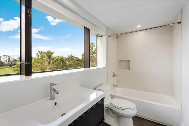 a bathroom with a sink a toilet and a bathtub