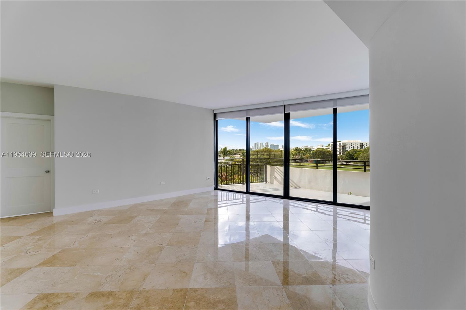 720 Northeast 69th Street, Unit 4S Miami, FL 33138 - Photo 3 of 46 wooden floor with windows in an empty room
