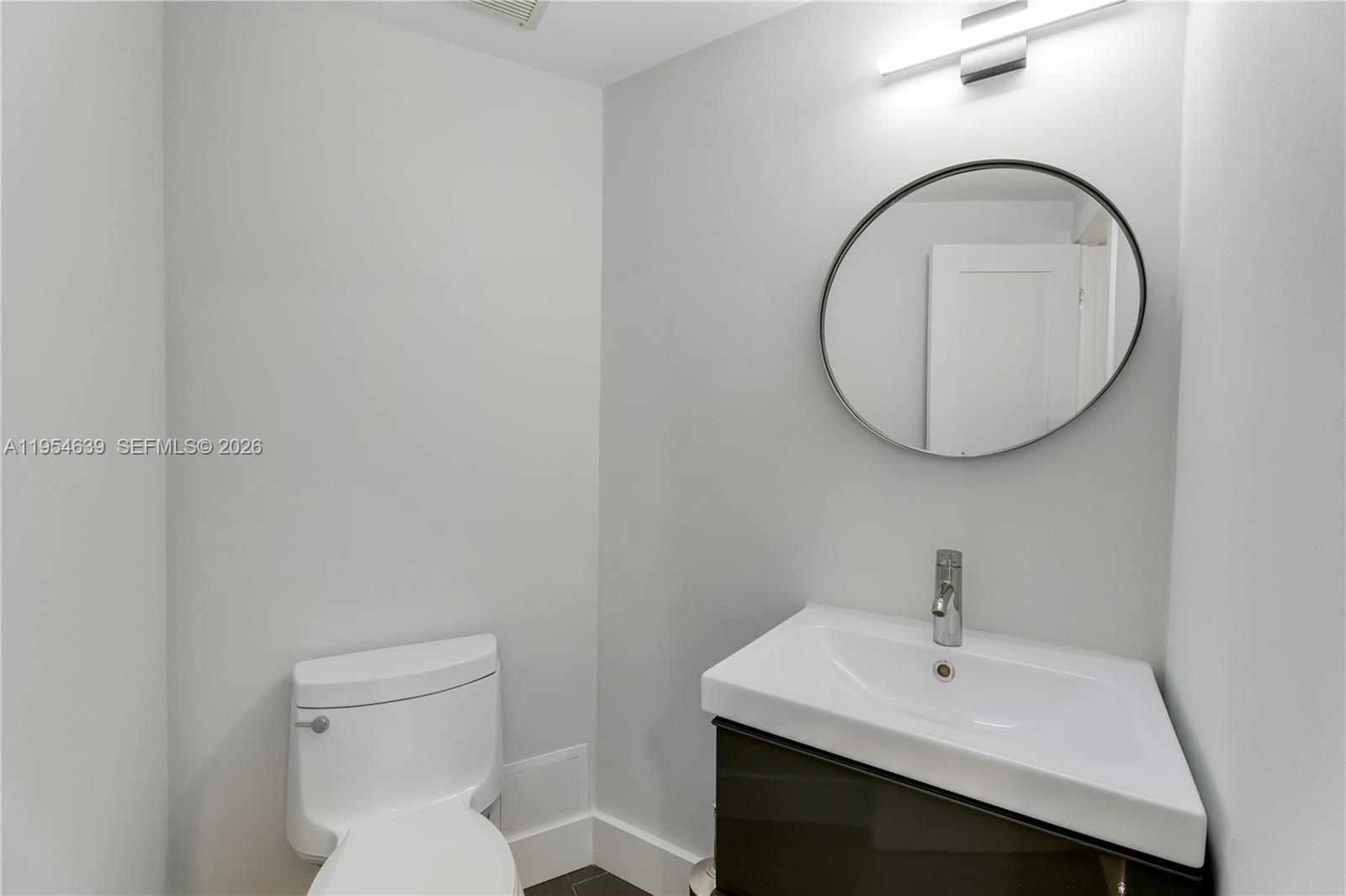 720 Northeast 69th Street, Unit 4S Miami, FL 33138 - Photo 32 of 46 a bathroom with a sink and a mirror