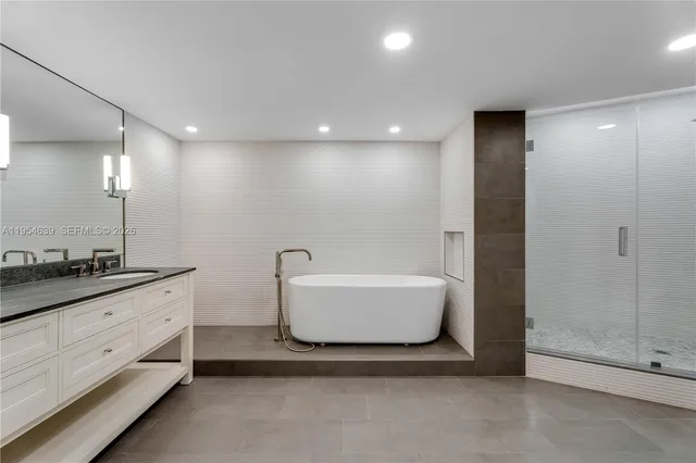 a bathroom with a bathtub and shower