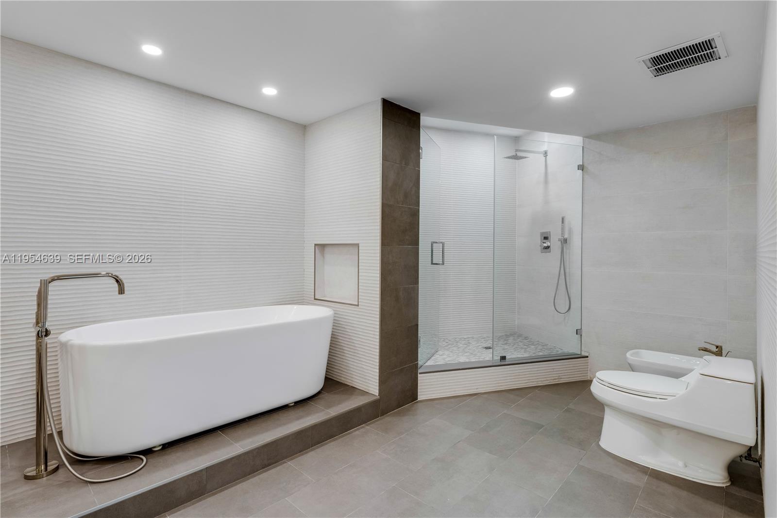 720 Northeast 69th Street, Unit 4S Miami, FL 33138 - Photo 38 of 46 a bathroom with a bathtub and shower