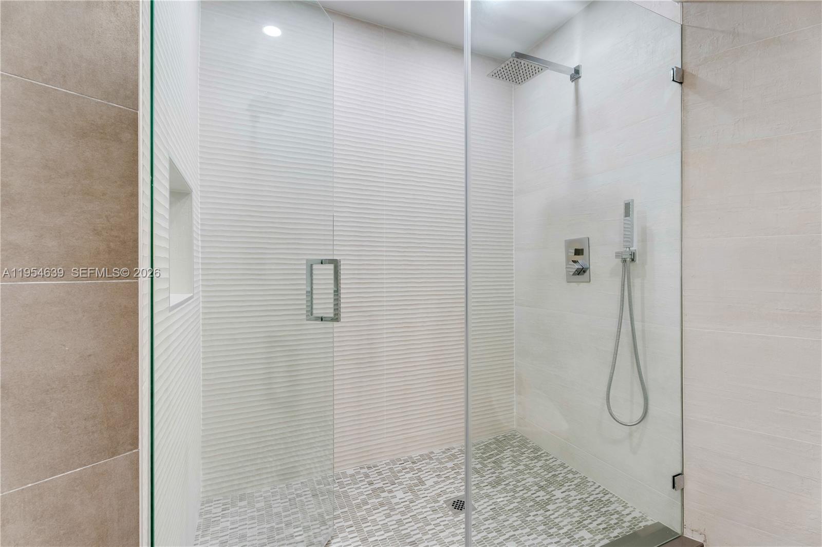 720 Northeast 69th Street, Unit 4S Miami, FL 33138 - Photo 39 of 46 a bathroom with a glass shower door