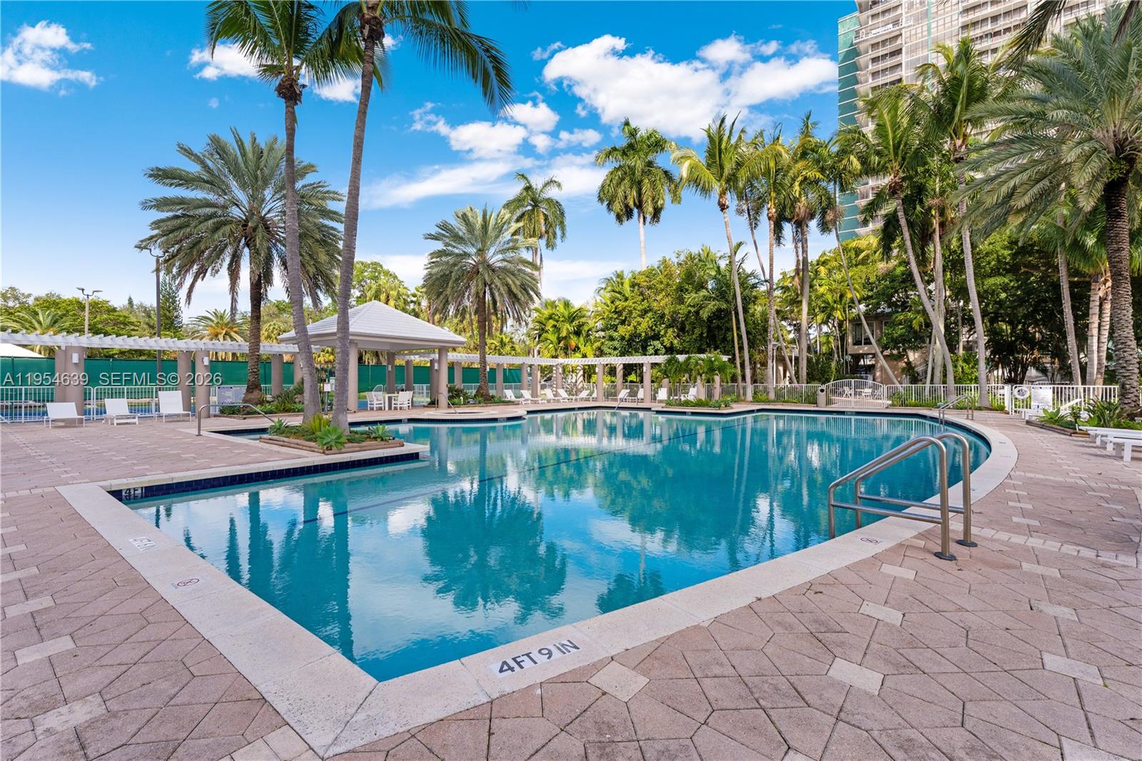 720 Northeast 69th Street, Unit 4S Miami, FL 33138 - Photo 41 of 46 a view of swimming pool with a table and chairs