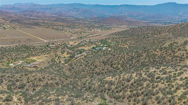 a view of a large mountain with mountains in the background