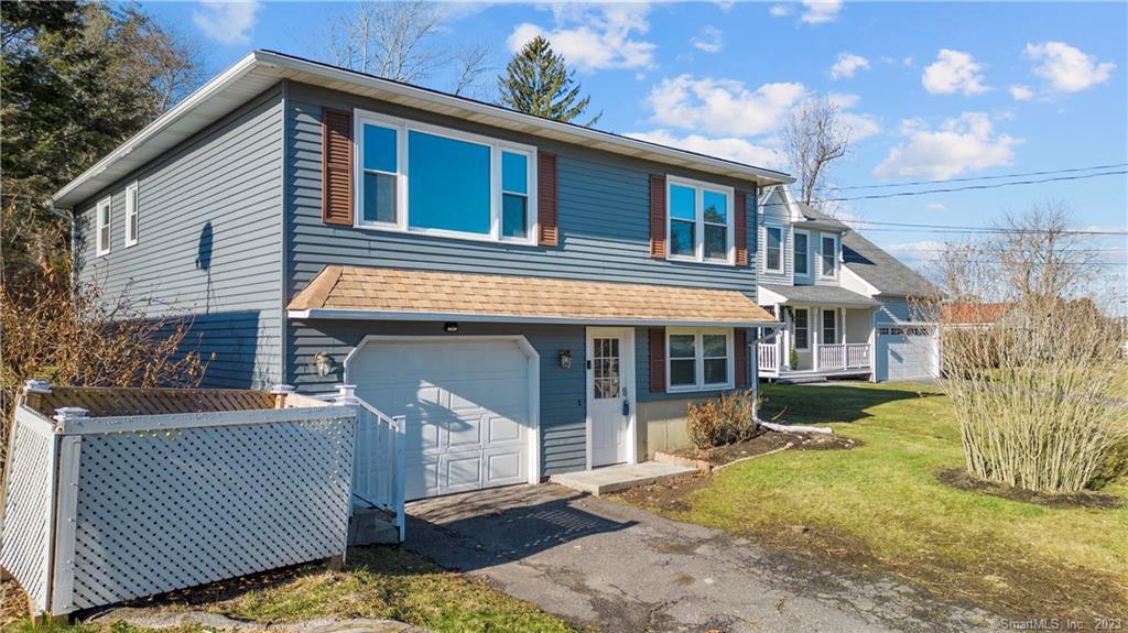 589 Lakeside Boulevard West Waterbury, CT 06708 - Photo 1 of 1 a front view of a house with a yard