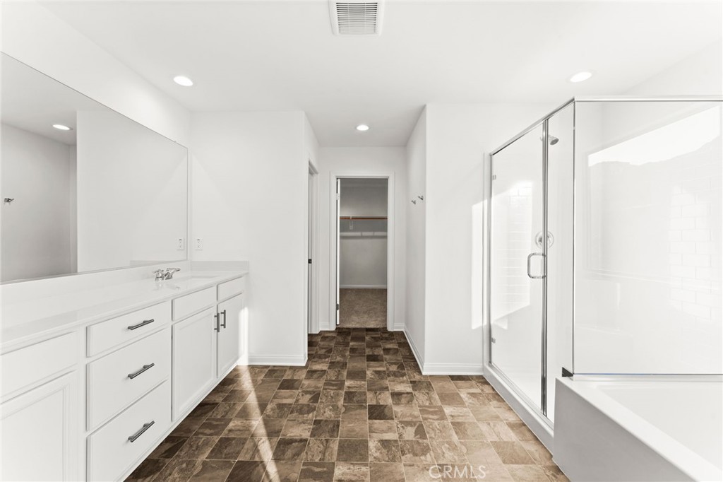 8465 Anthony Street Colton, CA 92324 - Photo 14 of 43 a bathroom with a double vanity sink a mirror and a shower