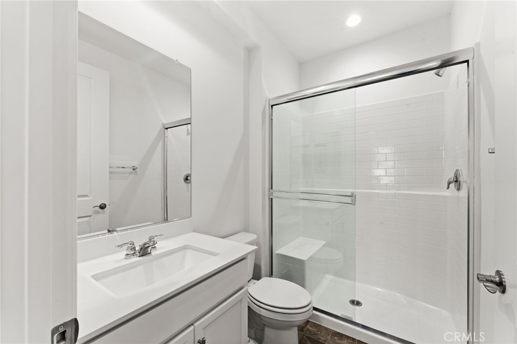 8465 Anthony Street Colton, CA 92324 - Photo 21 of 43 a bathroom with a sink mirror vanity and toilet