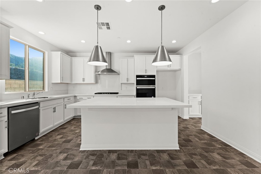 8465 Anthony Street Colton, CA 92324 - Photo 4 of 43 a kitchen with kitchen island a counter top space appliances and a cabinets