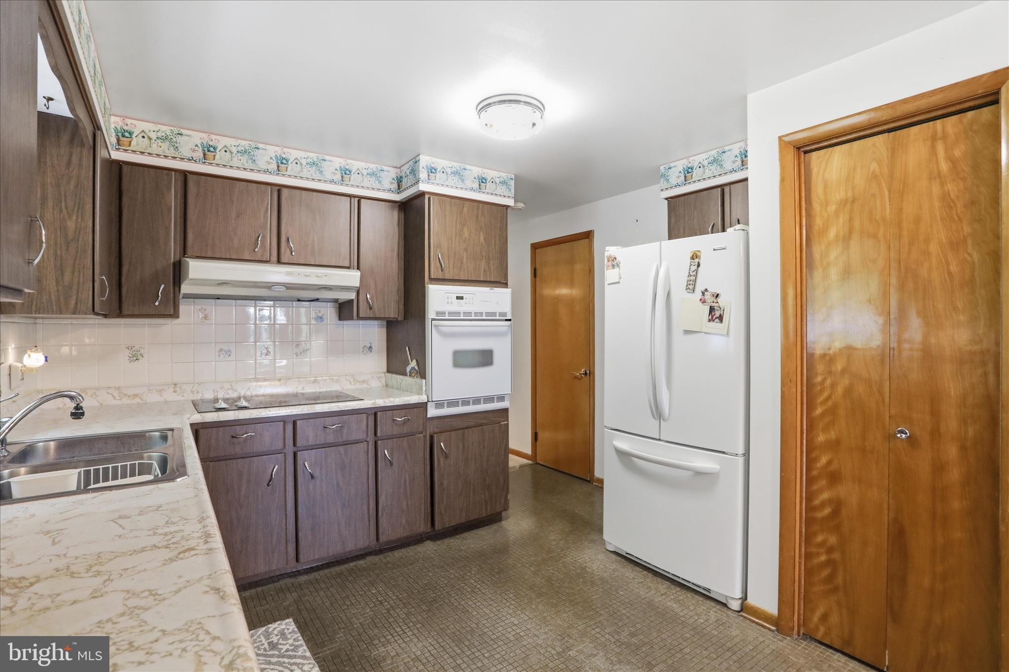 199 Buser Street Ridgeley, WV 26753 - Photo 10 of 49 a kitchen with stainless steel appliances granite countertop a refrigerator and a sink