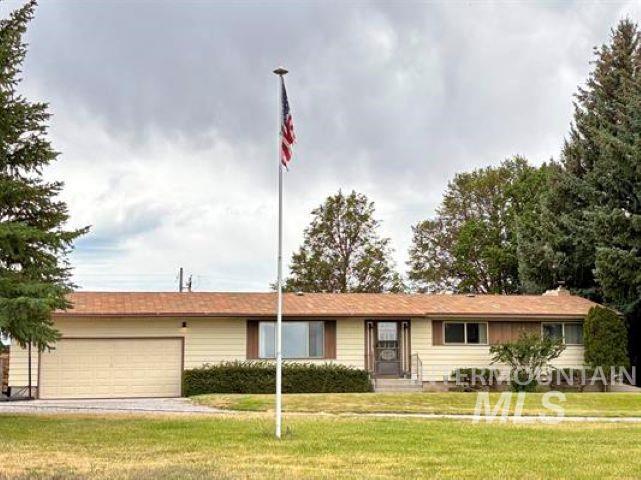 3197 Neeley Road American Falls, ID 83211 - Photo 1 of 45 Ranch-style residence featuring a prominent flagpole, attached garage, and mature landscaping