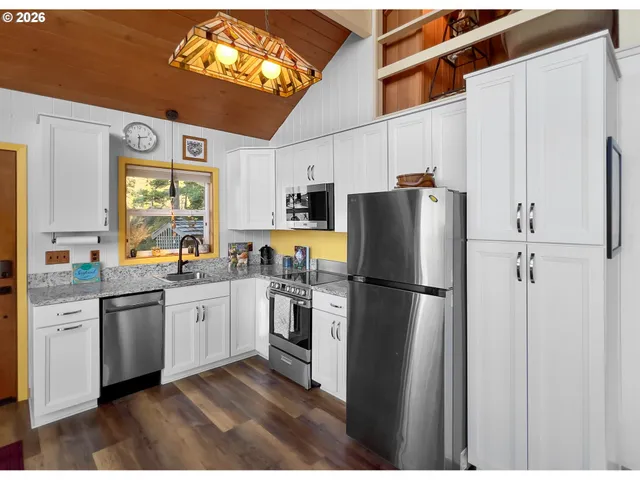 a kitchen with stainless steel appliances a refrigerator sink and microwave