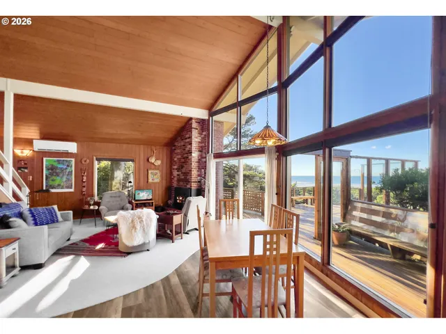 a living room filled with furniture and a large window