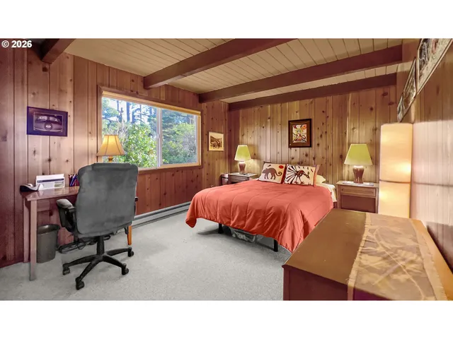 a bed room with a bed and a chair