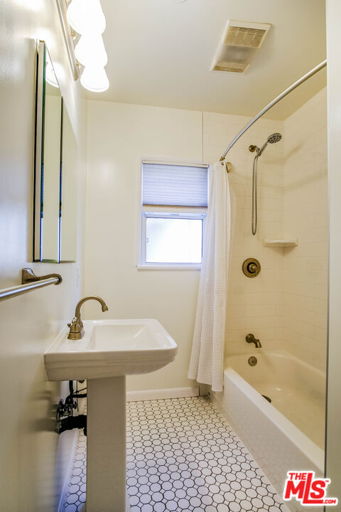 3564 Dover Street Los Angeles, CA 90039 - Photo 11 of 22 a bathroom with a sink a mirror and a bathtub