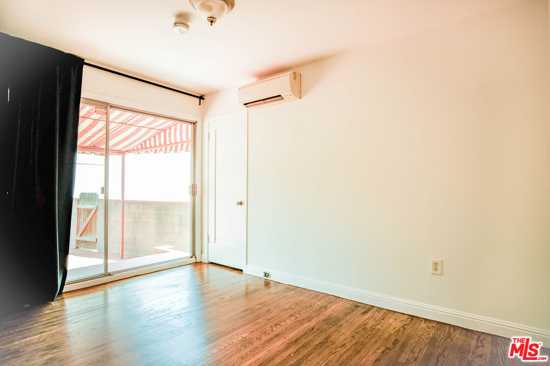 3564 Dover Street Los Angeles, CA 90039 - Photo 15 of 22 a view of an empty room with wooden floor and a window