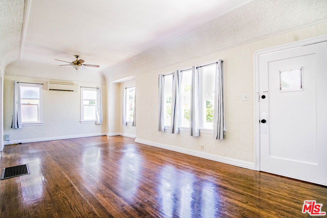 3564 Dover Street Los Angeles, CA 90039 - Photo 4 of 22 an empty room with wooden floor and windows