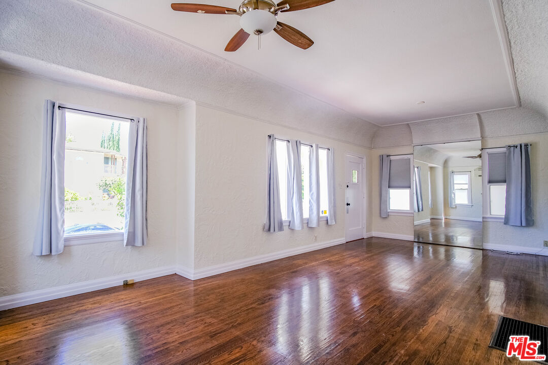 3564 Dover Street Los Angeles, CA 90039 - Photo 5 of 22 a view of an empty room with a window and wooden floor
