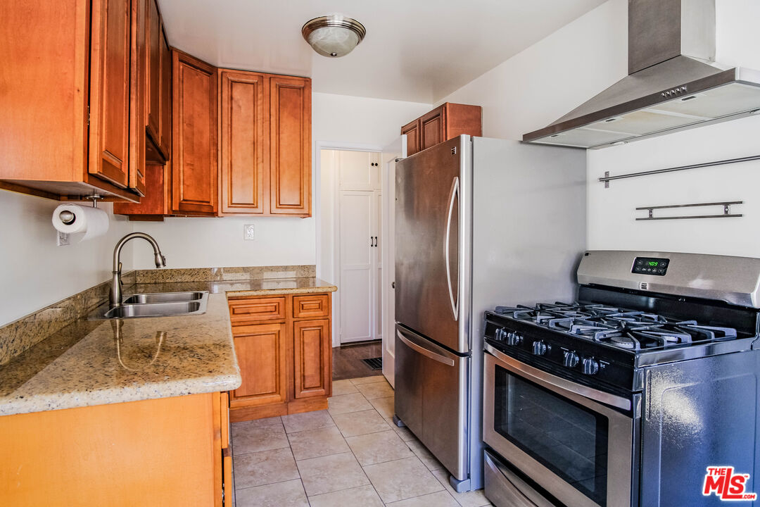 3564 Dover Street Los Angeles, CA 90039 - Photo 6 of 22 a kitchen with granite countertop a sink stove and refrigerator