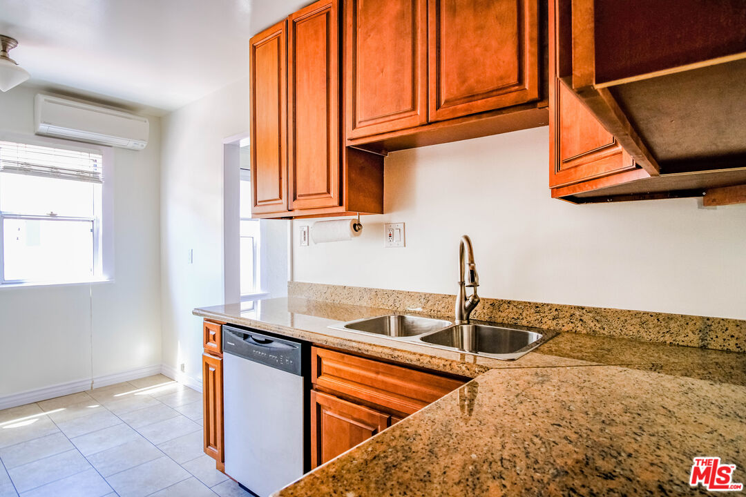 3564 Dover Street Los Angeles, CA 90039 - Photo 7 of 22 a kitchen with stainless steel appliances granite countertop a sink and a window