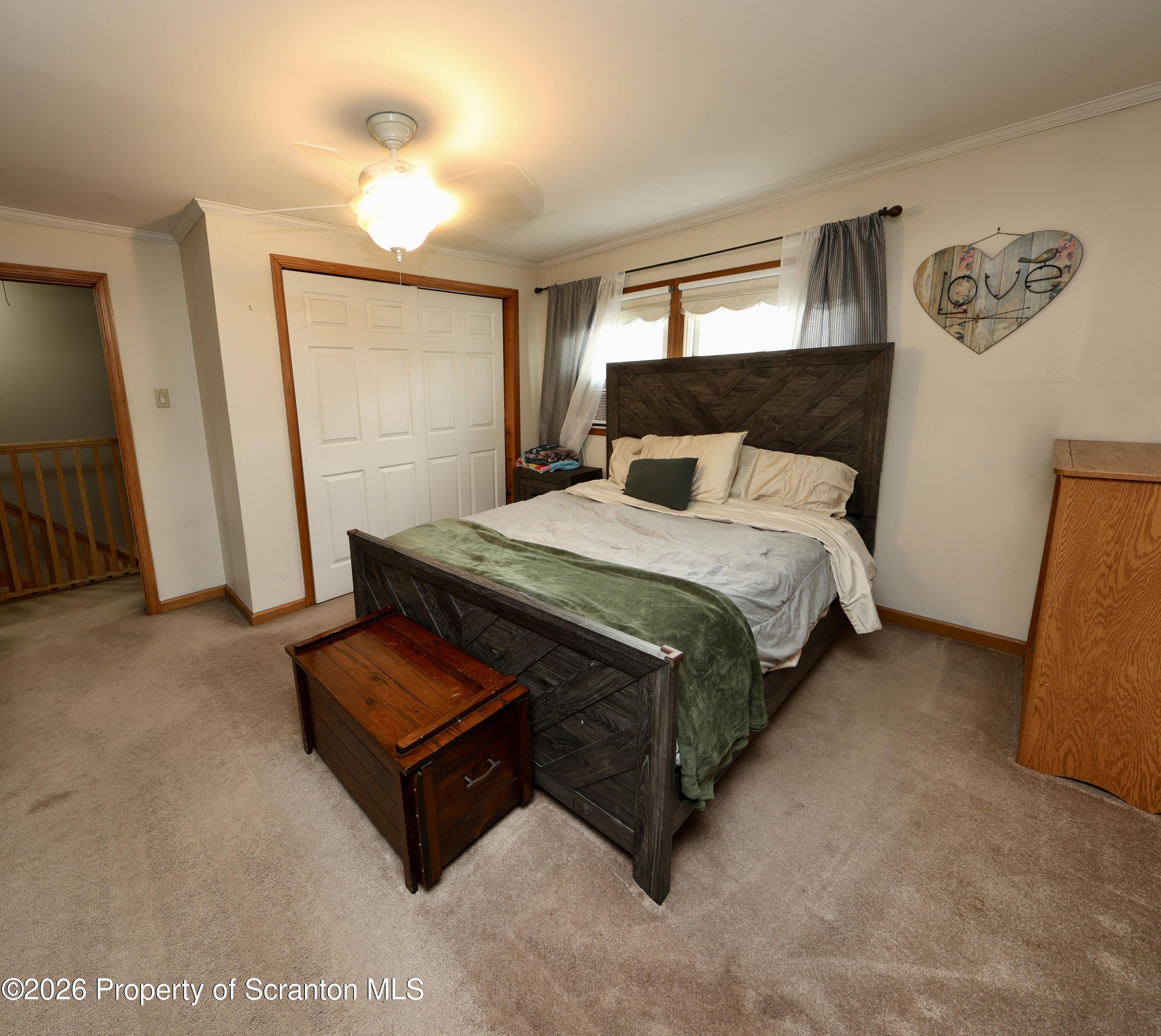 1338 Lafayette Street Scranton, PA 18504 - Photo 22 of 31 a bed sitting in a bedroom next to a window