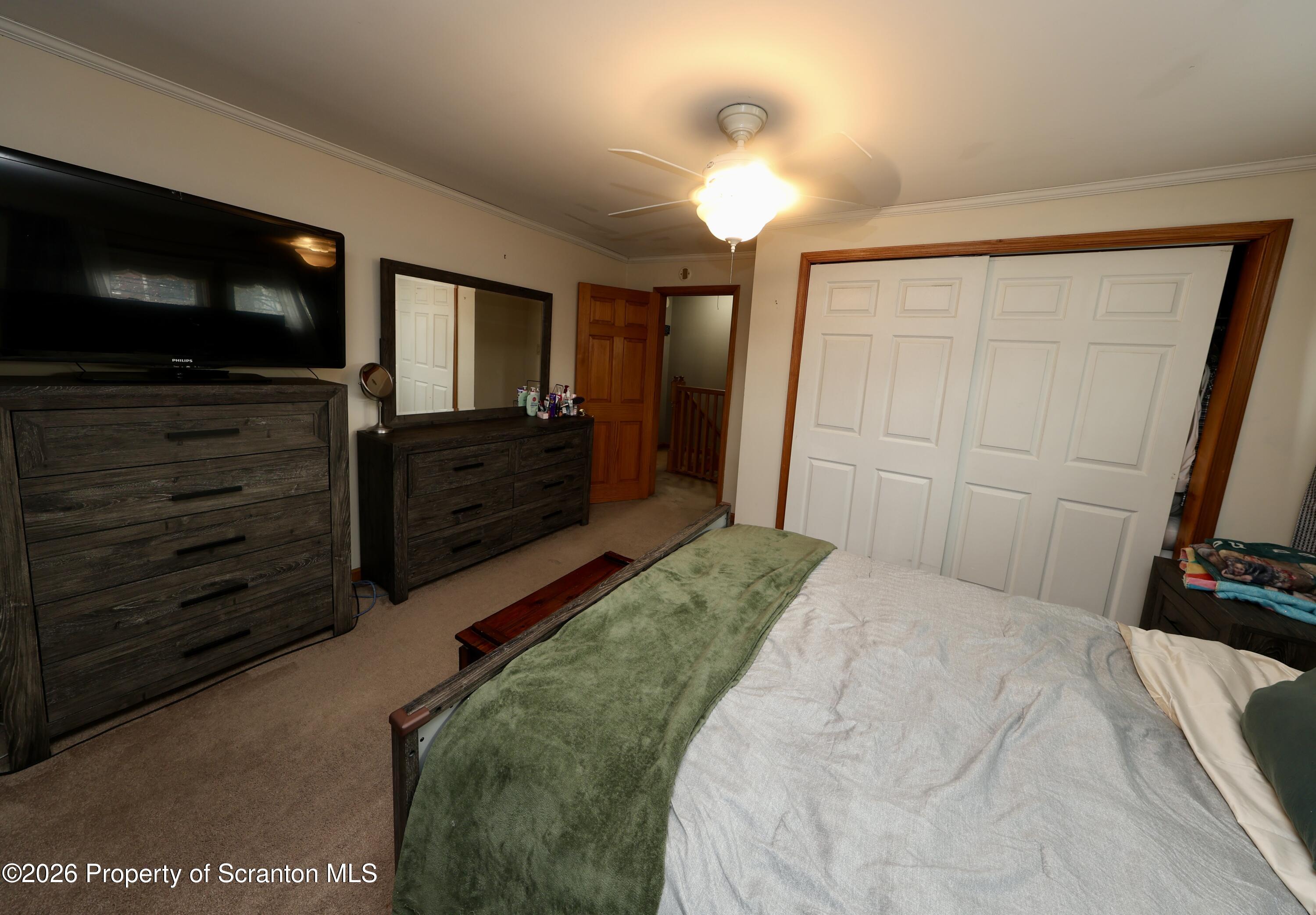 1338 Lafayette Street Scranton, PA 18504 - Photo 23 of 31 a bedroom with a bed and a flat screen tv