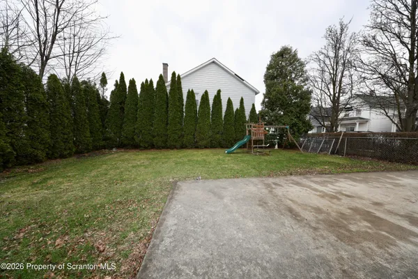 a view of a yard with a house in the background