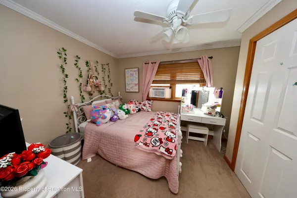 a bedroom with bed and a window