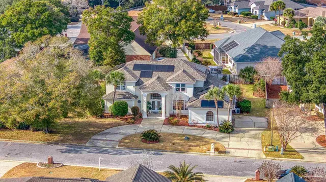 an aerial view of residential houses with outdoor space