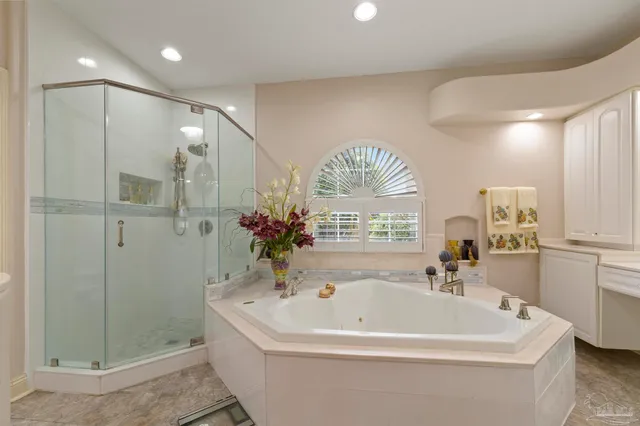 a view of a house with a large tree and a yard