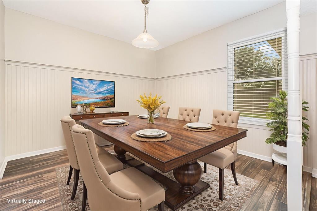 229 South Heartz Road Coppell, TX 75019 - Photo 7 of 18 Virtually staged-Dining area with dark wood-type flooring and wainscoting