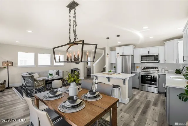 a open dining room with furniture wooden floor kitchen view and kitchen view