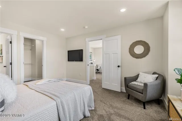 a bedroom with a bed and a television