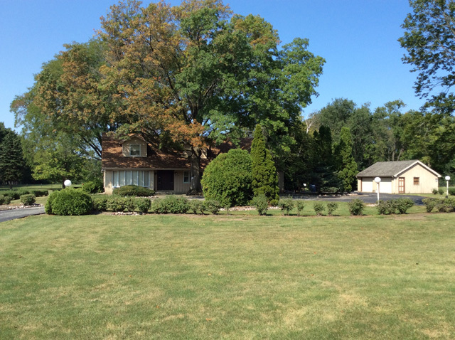8S220 College Road Naperville, IL 60540 - Photo 6 of 20 a front view of a house with a garden and trees